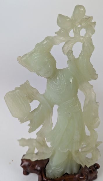CHINA, 20th century
GUANYN holding a carved...