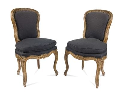 Pair of carved wood, molded and gilded chairs...