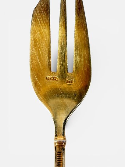 Set of nine dessert forks in gilt metal with...