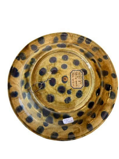 Round polychrome earthenware dish with an...