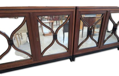 Two glass-fronted bookcases arranged side...