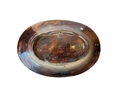 Large oval earthenware dish with a blue background,...
