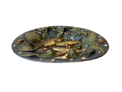 Large oval earthenware dish with a blue background,...