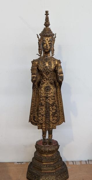 Standing Buddha in gilded bronze in the fearlessness...