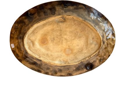 Large oval earthenware dish with a brown...