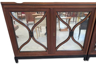 Two glass-fronted bookcases arranged side...