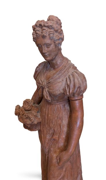 Terracotta garden sculpture depicting a young...