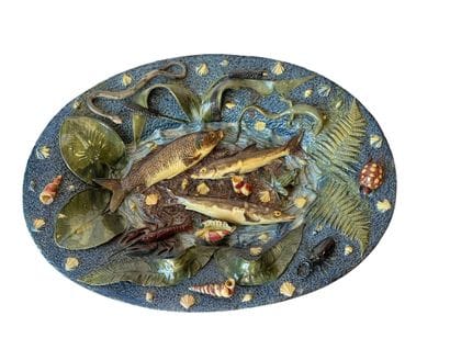 Large oval earthenware dish with a blue background,...