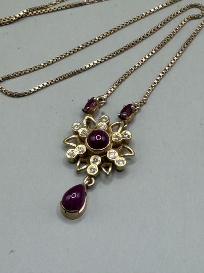 Gold necklace with a design set with ruby...