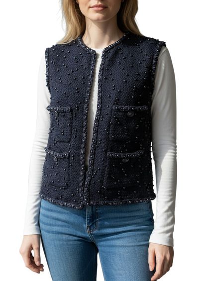 CHANEL. VESTE sans manches en laine noire...