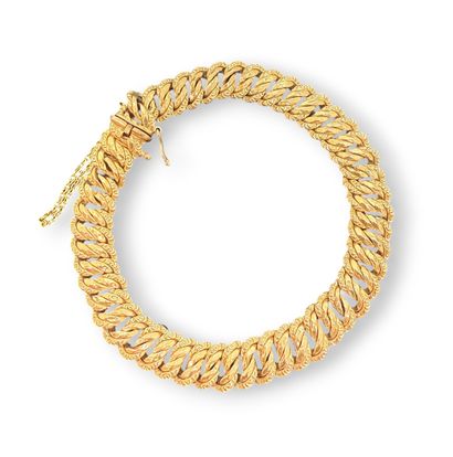 BRACELET en or jaune à double maille gourmette....