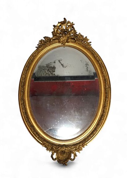Large oval MIRROR in stuccoed and gilded...
