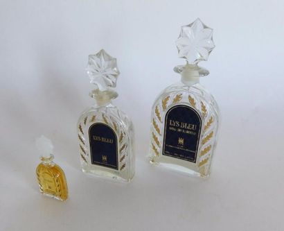 Le lys bleu. Trois flacons de taille différente,...