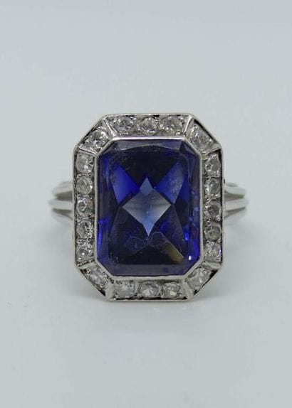 BAGUE en fils d'or gris, ornée d'un saphir...