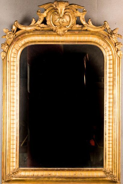 Wood and gilded stucco mirror, openwork pediment....