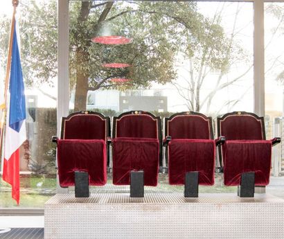 Row of theatre seats in black lacquered wood...