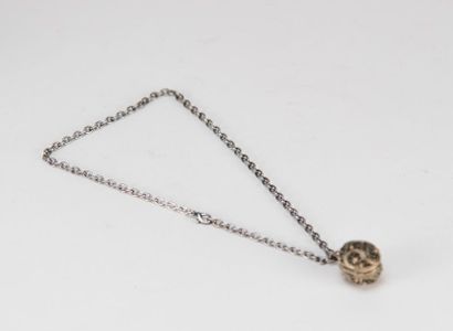 Small openwork silver egg containing a miniature...