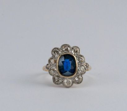 Daisy ring adorned with an oval sapphire...