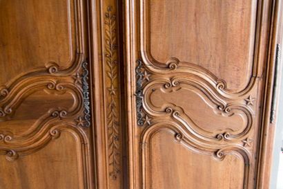 Walnut wardrobe molded and carved with flowers,...