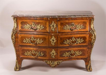 A chest of drawers made of veneered wood...