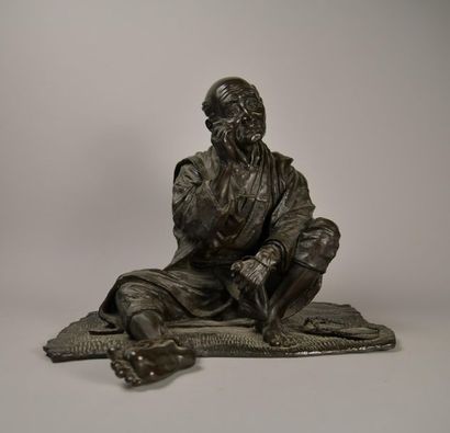 JAPON. Fumeur d'opium. Bronze à patine brune....