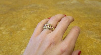 Bandeau ring adorned with three lines, one...