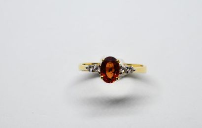 Modern ring with an oval-shaped orange sapphire...