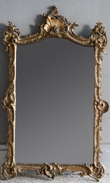 Mirror with stuccoed and gilded wood frame...