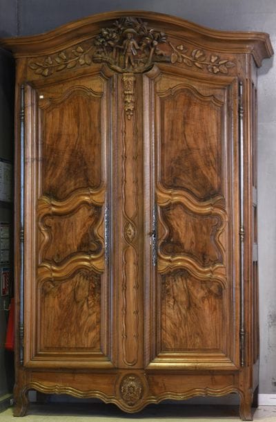 *A carved and moulded walnut cabinet, the...