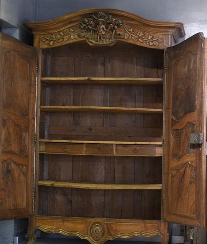 *A carved and moulded walnut cabinet, the...