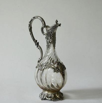 Crystal decanter with twisted ribs, the silver...