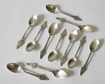 Suite of eleven silver teaspoons richly decorated...