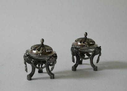 Pair of tripod chiselled silver saltcellars...
