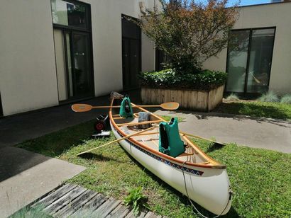 Old Town canoe in painted wood, and its accessories:...