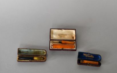 Set of 3 amber, gilt and gold cigarette holders....