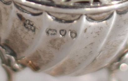 Pair of silver tripod salt shakers, the neck...