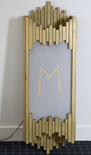 A free-form wall light, made of gilded steel...