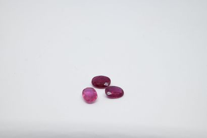 Lot of three faceted oval rubies on paper,...