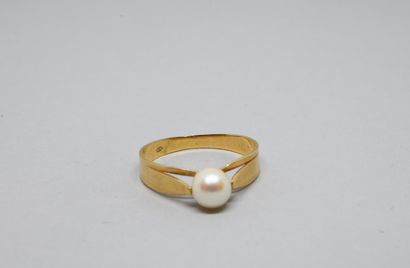Bague en or jaune 750‰, centrée d'une perle...