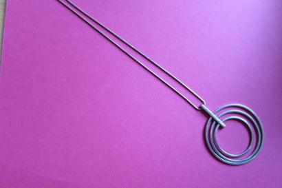Silver necklace with snake chain and stylized...