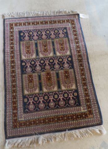 Small woolen carpet with arcature and geometrical...
