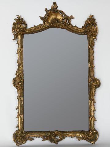 A stuccoed and gilded wood framed mirror...