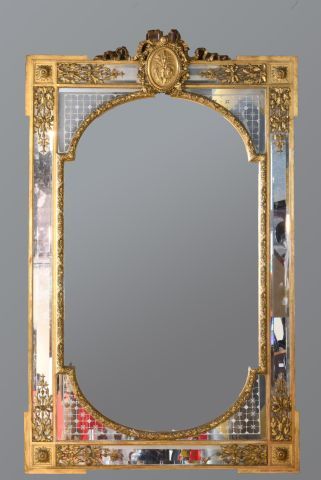 Large gilded and stuccoed wood mirror with...