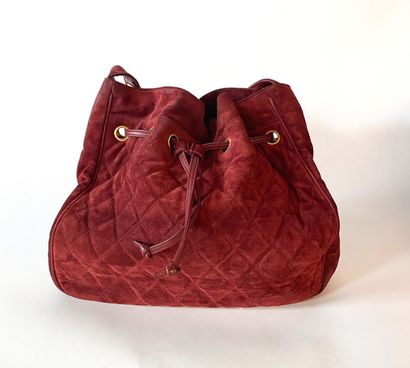 CHANEL. Circa 1994. Bag in burgundy suede...