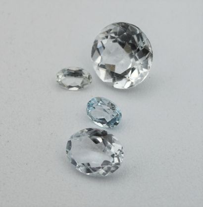 Four aquamarines (three oval, one round)...