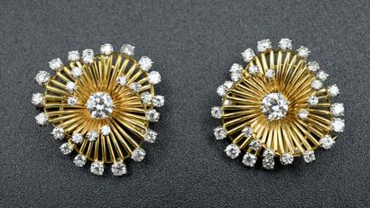 Pair of spiral brooches with modern cut diamonds.

The...