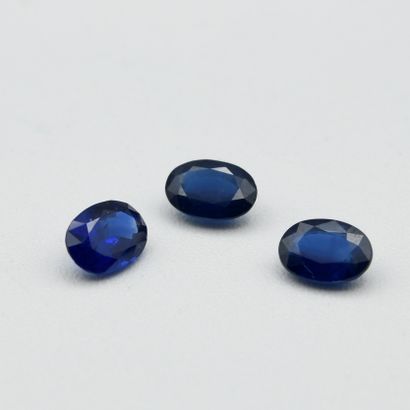 Three dark sapphires on treated paper, oval...