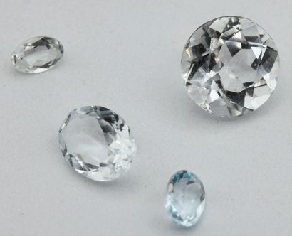 Four aquamarines (three oval, one round)...