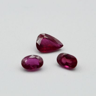 Three rubies on paper, one pear cut, the...