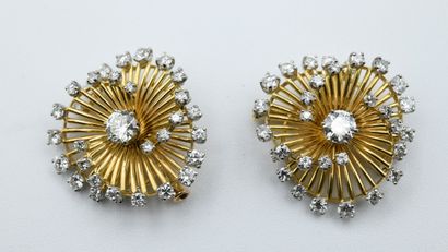 Pair of spiral brooches with modern cut diamonds.

The...